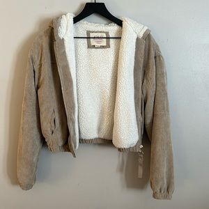 Cute, ribbed, light tan jacket with fluffy white lining.
